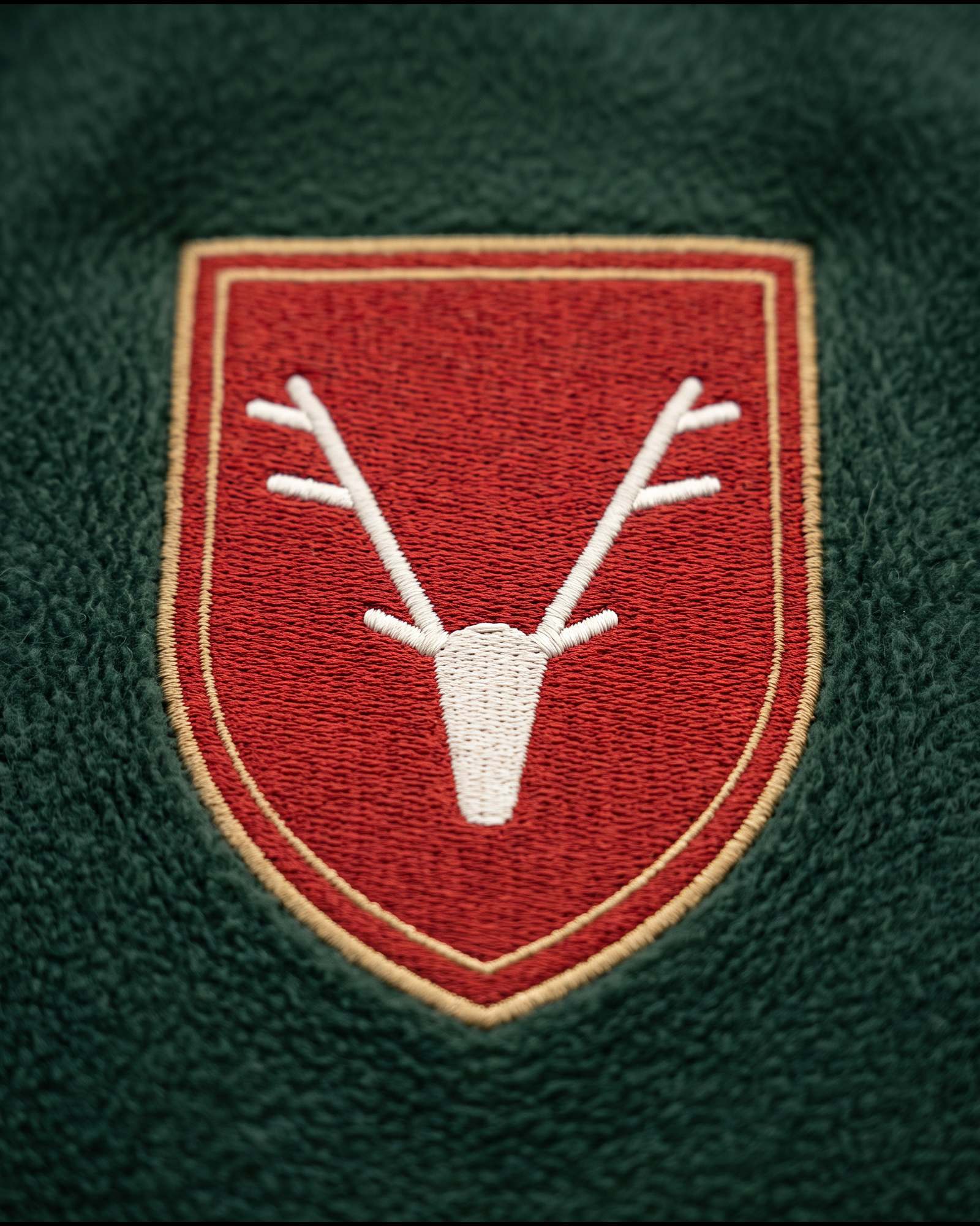 The raised embroidered crest on The Delamere Hoodie